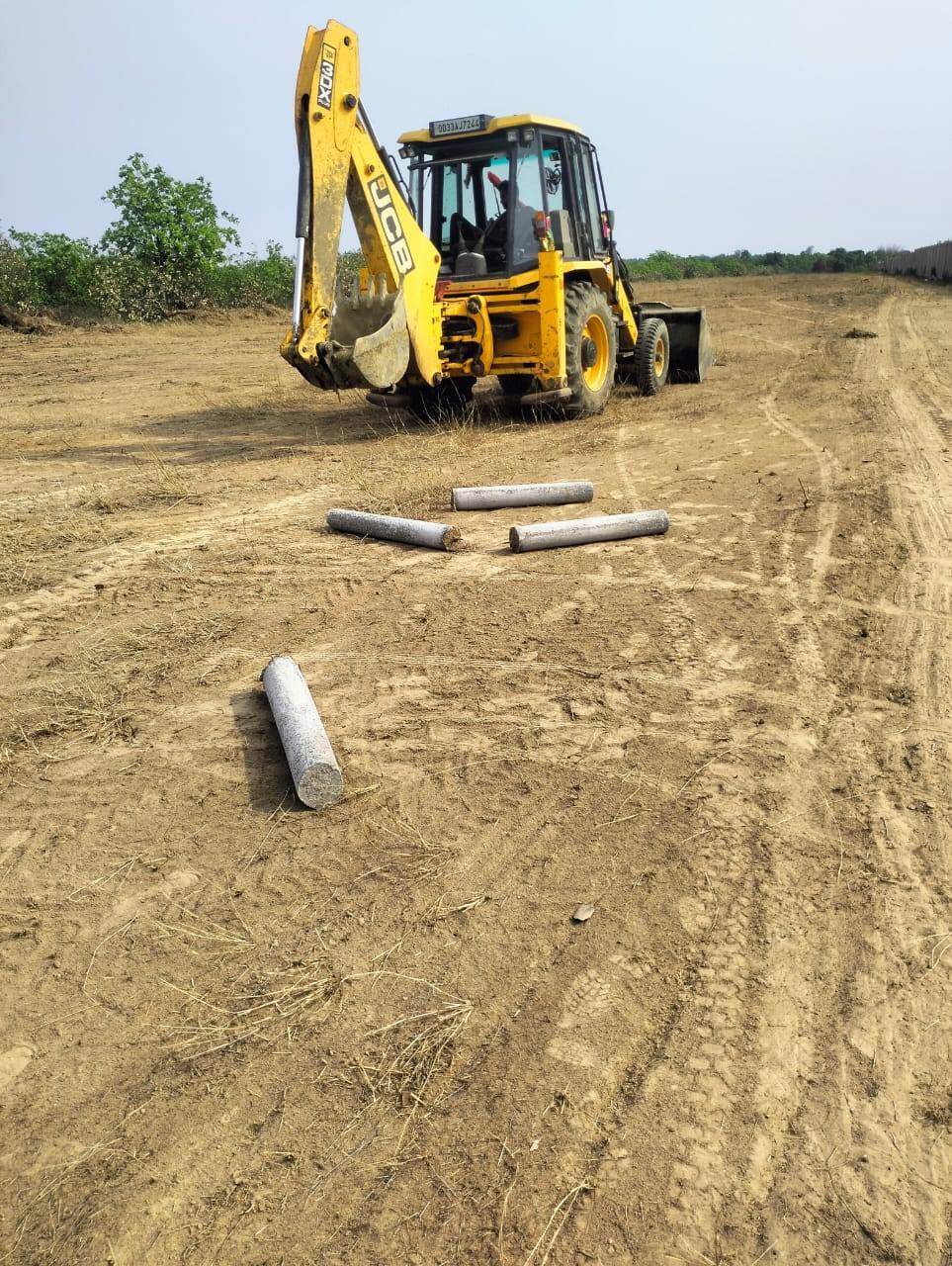 Excavator and concrete plotting pillars on the Greenwave project site